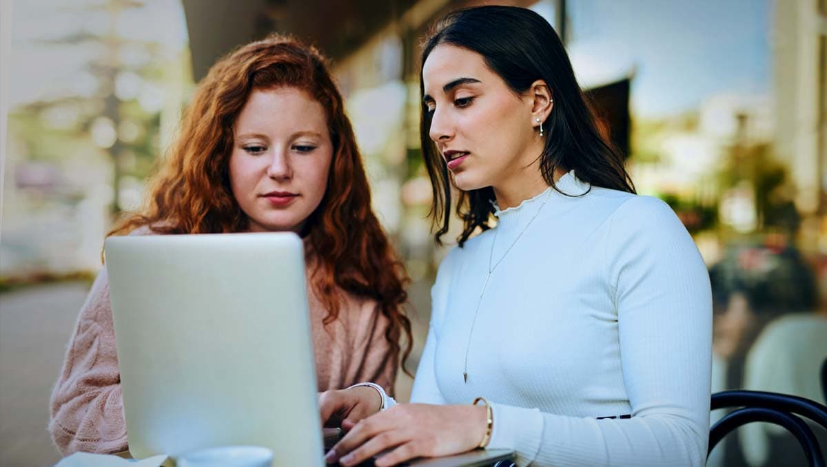 two ladies looking at computer