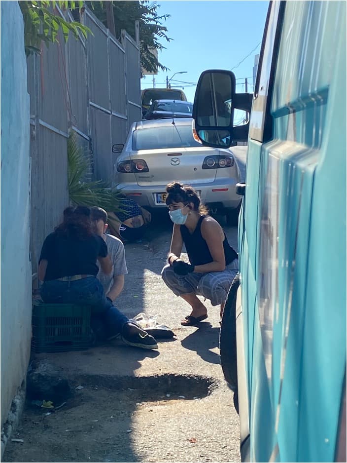 Maayan talks to people on the street.